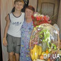 Fruit basket with champagne and flowers