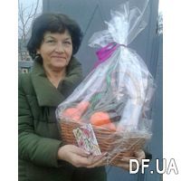 Basket with tangerines, sweets and spruce