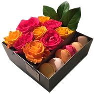Box with fresh flowers and sweets