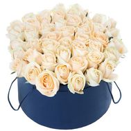 Cream roses in a round box