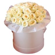 Cream roses in a round box