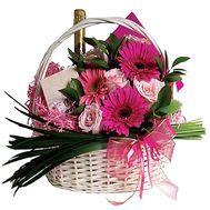 Basket with sweets, champagne and flowers