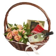 Flowers and sweets with wine in the basket