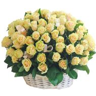 Cream roses in a basket with a bow