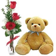 A teddy bear with 3 roses