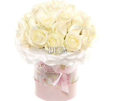 White roses in a box with a bow
