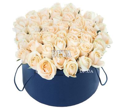 Cream roses in a round box
