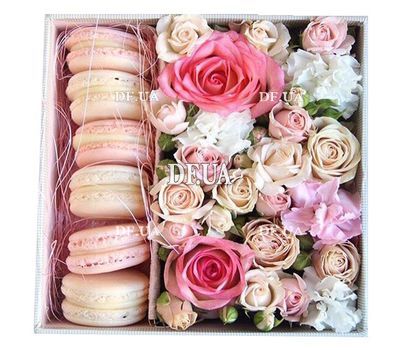 Macaroons with flowers in a box