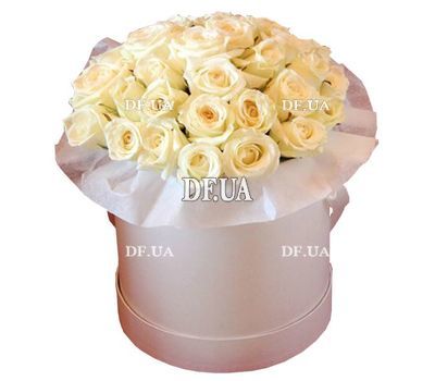 Cream roses in a round box