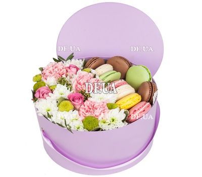 Macaroons and flowers in a box